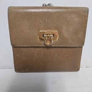 The Salvatore Ferragamo Gancini Clasp Trifold Leather Wallet in brown with gold